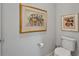 Stylish powder room features contemporary artwork and clean, modern fixtures at 19165 Iron Topsail Isle, Land O Lakes, FL 34638