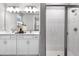 Modern bathroom with double vanity, bright lighting, and a sleek glass-enclosed shower at 9211 Players Dr, Weeki Wachee, FL 34613
