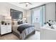 Inviting bedroom featuring a bed, white dressers, a window, and gray-tone decor at 9211 Players Dr, Weeki Wachee, FL 34613