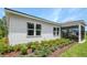Side exterior view of home with white siding, manicured lawn and screened lanai at 9211 Players Dr, Weeki Wachee, FL 34613