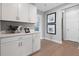 Stylish hallway featuring white cabinetry, quartz countertops, and views of the rest of the home at 9211 Players Dr, Weeki Wachee, FL 34613