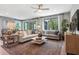 A spacious living room is complete with stylish furniture and large windows at 9211 Players Dr, Weeki Wachee, FL 34613