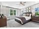 Serene main bedroom with large windows, neutral decor, and ample closet space at 9211 Players Dr, Weeki Wachee, FL 34613