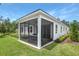 Relaxing screened patio with outdoor dining set, offering great views of the backyard at 9211 Players Dr, Weeki Wachee, FL 34613