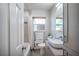 Well-lit bathroom featuring modern fixtures, a large mirror, natural light, and neutral-toned tile in the shower at 2601 Upton S St, Gulfport, FL 33711