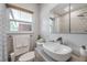 Stylish bathroom features an oval sink, large mirror, modern fixtures, and a window providing natural light at 2601 Upton S St, Gulfport, FL 33711