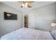 Bedroom featuring queen bed with a ceiling fan, mounted TV, and closet access at 2601 Upton S St, Gulfport, FL 33711