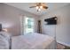 Comfortable bedroom showcases a queen bed, ceiling fan, and a large window with natural light at 2601 Upton S St, Gulfport, FL 33711