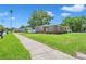 Well-maintained brick home with manicured lawn, complemented by a sidewalk and lush greenery at 2601 Upton S St, Gulfport, FL 33711