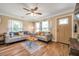 Bright living room featuring hardwood floors, stylish furnishings, a ceiling fan, and plenty of natural light at 2601 Upton S St, Gulfport, FL 33711