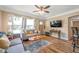 Sunlit living room with hardwood floors, comfortable seating, ceiling fan, and open access to the kitchen at 2601 Upton S St, Gulfport, FL 33711