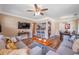 Comfortable living room with hardwood floors, stylish decor, ceiling fan, and an open layout to the kitchen and dining area at 2601 Upton S St, Gulfport, FL 33711