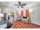 Cozy home office with terra cotta tile floors, white walls, and a stylish wicker seat with storage at 2601 Upton S St, Gulfport, FL 33711