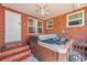 Covered outdoor patio featuring a luxurious hot tub, perfect for relaxation and entertainment at 2601 Upton S St, Gulfport, FL 33711