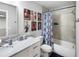 Well-lit bathroom features a tub with shower, vanity with marble counter, and modern fixtures at 5367 Riverwalk Preserve Dr, New Port Richey, FL 34653