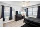 Comfortable bedroom features a ceiling fan, natural light, laminate floor, and decor at 5367 Riverwalk Preserve Dr, New Port Richey, FL 34653