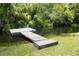 Wooden dock on the water surrounded by green grass and a lush landscape at 5367 Riverwalk Preserve Dr, New Port Richey, FL 34653