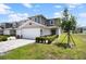 Charming two-story townhome featuring an attached two-car garage and beautifully maintained front yard landscaping at 5367 Riverwalk Preserve Dr, New Port Richey, FL 34653