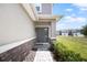 Inviting front entrance features a stylish front door, stone accents, and manicured shrubbery leading to the home at 5367 Riverwalk Preserve Dr, New Port Richey, FL 34653