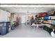 This spacious garage features epoxy flooring and ample storage for vehicles and projects at 5367 Riverwalk Preserve Dr, New Port Richey, FL 34653