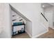 Hallway with a bonus storage area or nook under the stairs, perfect for displaying books and collectables at 5367 Riverwalk Preserve Dr, New Port Richey, FL 34653