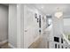 Bright hallway with wood floors, chandelier lighting, and access to multiple rooms at 5367 Riverwalk Preserve Dr, New Port Richey, FL 34653