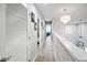 Bright hallway with wood floors, chandelier lighting, and access to multiple rooms at 5367 Riverwalk Preserve Dr, New Port Richey, FL 34653