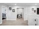 Upstairs hallway featuring a workstation nook with a white chair and black desk at 5367 Riverwalk Preserve Dr, New Port Richey, FL 34653