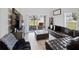 Living room featuring a comfortable leather sectional and natural light at 5367 Riverwalk Preserve Dr, New Port Richey, FL 34653