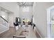 Open concept living room with a large dining table and vaulted ceilings at 5367 Riverwalk Preserve Dr, New Port Richey, FL 34653
