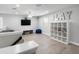 Spacious playroom with a TV, shelving unit, and a blue beanbag chair; perfect for Gathering fun at 5367 Riverwalk Preserve Dr, New Port Richey, FL 34653