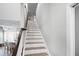View of the staircase with wooden steps and white risers leading to the upper level of the home at 5367 Riverwalk Preserve Dr, New Port Richey, FL 34653