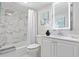 Modern bathroom with a tiled shower and vanity at 10365 Paradise Blvd # 21, Treasure Island, FL 33706