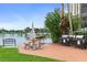 Community area with picnic tables, grills, water view, and lush landscaping at 10365 Paradise Blvd # 21, Treasure Island, FL 33706