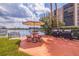 Water view community area with picnic tables, grills, and lush landscaping at 10365 Paradise Blvd # 21, Treasure Island, FL 33706