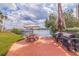 Community area with picnic tables, grills, water view, and lush landscaping at 10365 Paradise Blvd # 21, Treasure Island, FL 33706