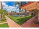 Beautiful courtyard view with a community pool, palm trees, and walkways in a well maintained community at 10365 Paradise Blvd # 21, Treasure Island, FL 33706