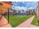 Well-kept courtyard with a community pool surrounded by palm trees and low-rise buildings for a relaxing atmosphere at 10365 Paradise Blvd # 21, Treasure Island, FL 33706
