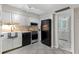 Well-lit kitchen with stainless appliances, white cabinetry, and modern sink at 10365 Paradise Blvd # 21, Treasure Island, FL 33706