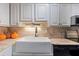 Bright kitchen with a farmhouse sink, wooden countertop, and modern appliances at 10365 Paradise Blvd # 21, Treasure Island, FL 33706