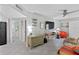 Inviting living room with tiled floors, ceiling fan, and neutral tones at 10365 Paradise Blvd # 21, Treasure Island, FL 33706