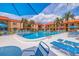 Inviting pool area with palm trees and community buildings at 10365 Paradise Blvd # 21, Treasure Island, FL 33706