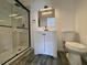 Modern bathroom with glass shower, white vanity, and sleek black fixtures at 4546 Ontario Dr, New Port Richey, FL 34652