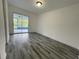 Bedroom with tile flooring and sliding glass doors leading to an enclosed porch at 4546 Ontario Dr, New Port Richey, FL 34652