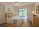 Cozy bedroom with a woven headboard, light wood dresser, and a screened patio view at 4546 Ontario Dr, New Port Richey, FL 34652