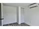 Minimalist bedroom featuring clean lines, white walls, and a wall-mounted AC unit at 4546 Ontario Dr, New Port Richey, FL 34652