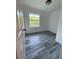 Bright bedroom featuring wood-look floors and a large window offering ample natural light at 4546 Ontario Dr, New Port Richey, FL 34652