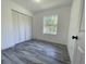 Bedroom with tile flooring, white walls and a window overlooking the exterior landscape at 4546 Ontario Dr, New Port Richey, FL 34652