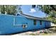 The home's exterior features a textured blue exterior and windows that provide plenty of natural light at 4546 Ontario Dr, New Port Richey, FL 34652