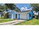 Charming home with bright blue siding, white trim, attached garage, and a well-manicured lawn at 4546 Ontario Dr, New Port Richey, FL 34652